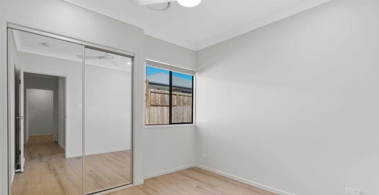 Bright bedroom in South Ripley home with timber floors.