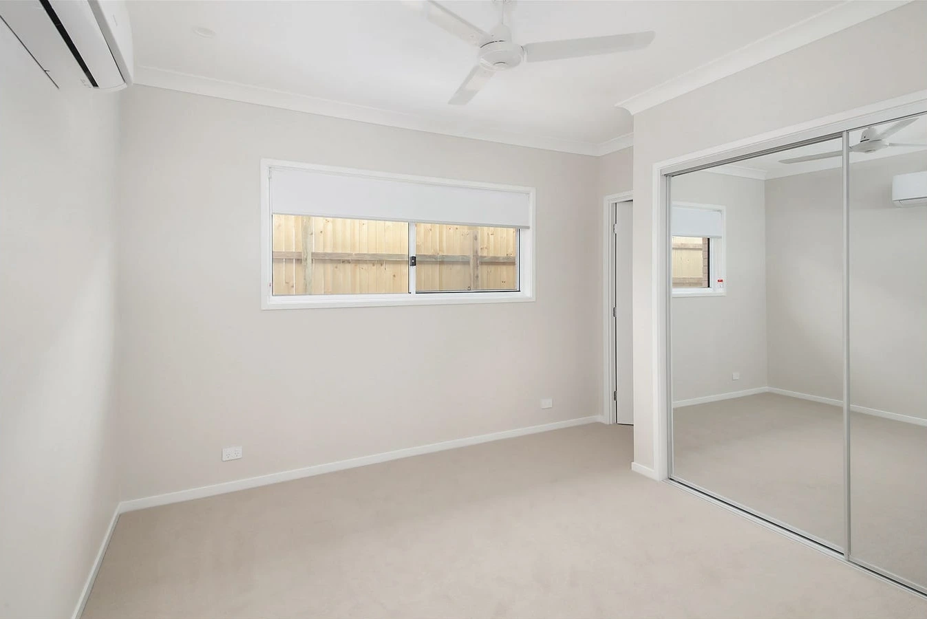 Bedroom in 8 Lilly Lane home in Logan with ceiling fan, ensuite, and soft carpeting.