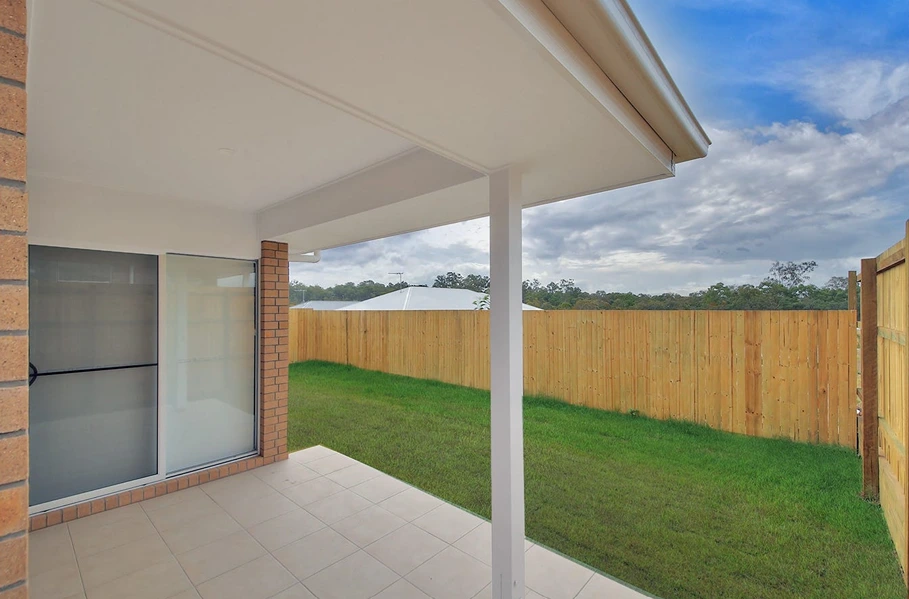 Covered patio and fenced backyard in family home at 8 Lilly Lane, Logan.