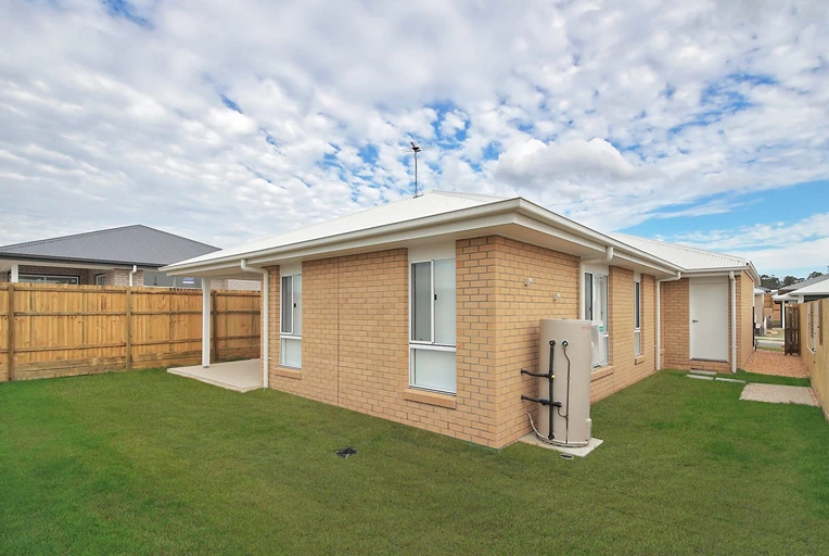 Brick exterior of modern home in Logan at 8 Lilly Lane with front lawn.