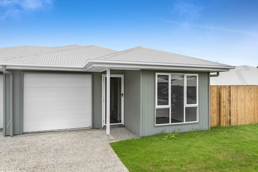 Modern street-facing facade of 1/7 Loch Way duplex in Brassall with light-toned exterior.