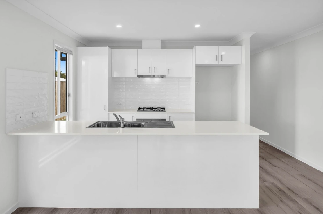 Open-plan kitchen with island bench in duplex at 1/7 Loch Way, Brassall.