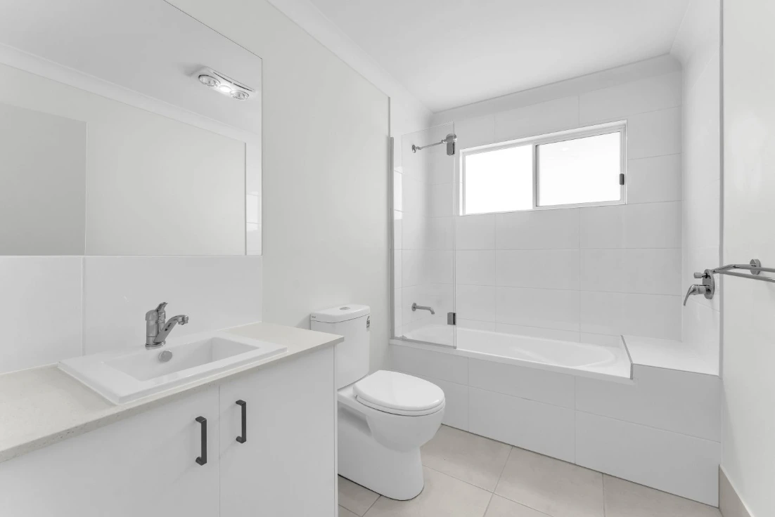 Main bathroom in duplex at 1/7 Loch Way, Brassall with bath, shower, and toilet.