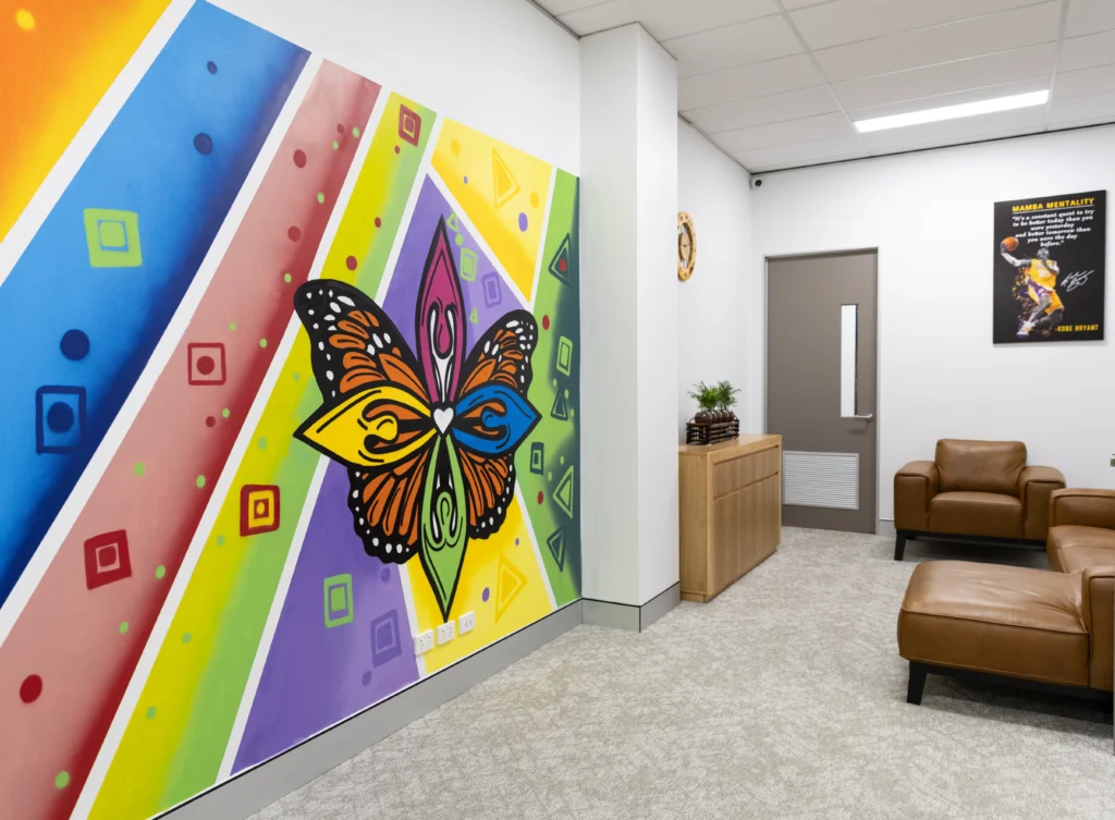 Butterfly mural inside The Legacy Hub Ipswich event space with seating area