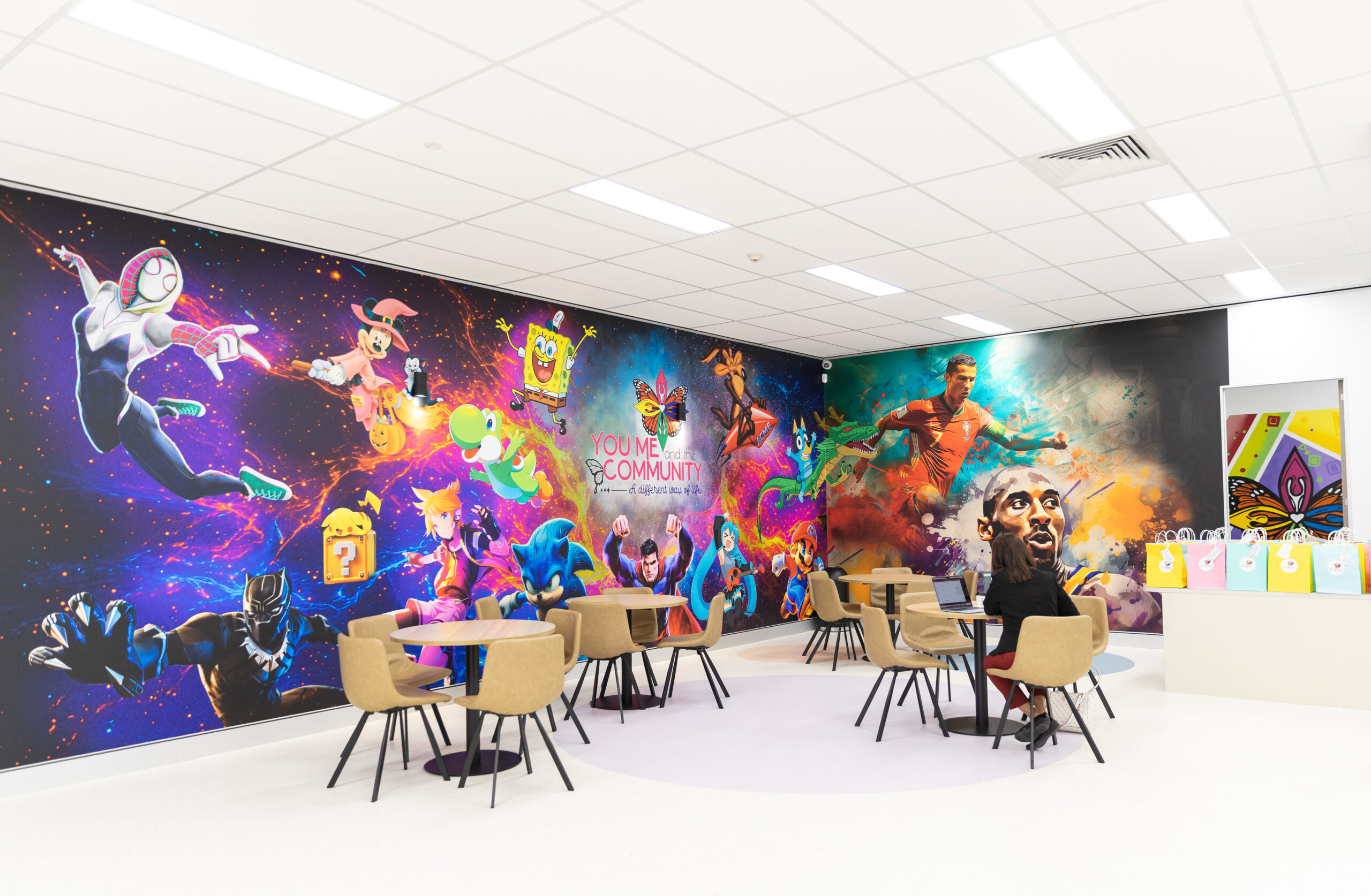 Colourful modern space at You Me and the Community showcasing Event Venue Hire in Ipswich with creative wall art and flexible seating.