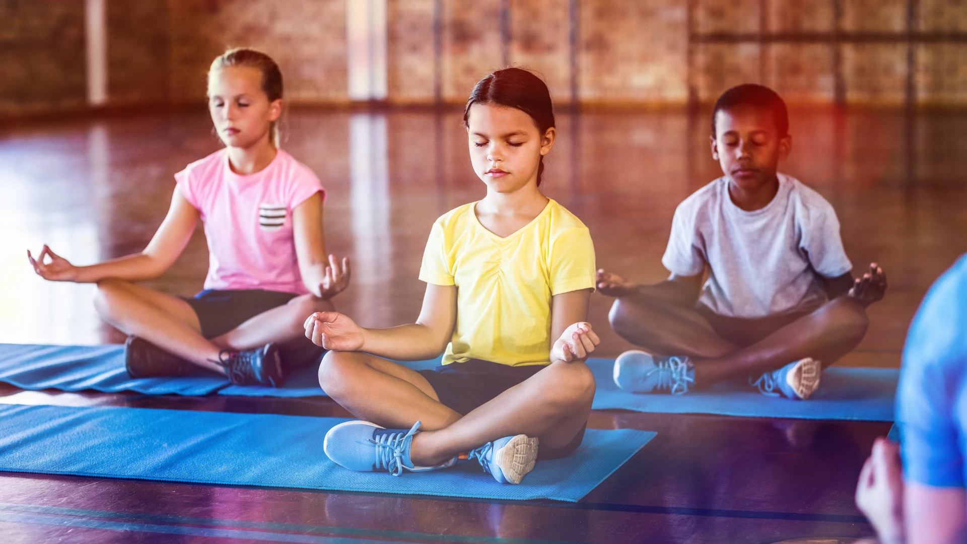 0-Benefits-of-yoga-for-kids-is-shown-with-kids-sitting-quietly-in-Easy-Sitting-Pose Yoga for kids events in You Me & Community