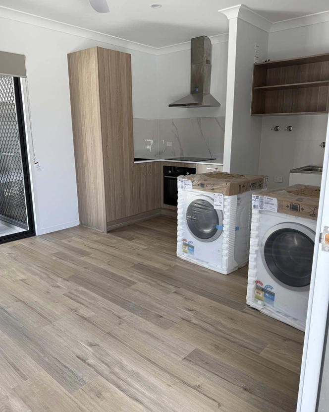 Kitchen with laundry appliances at You Me and the Community, Acacia Ridge