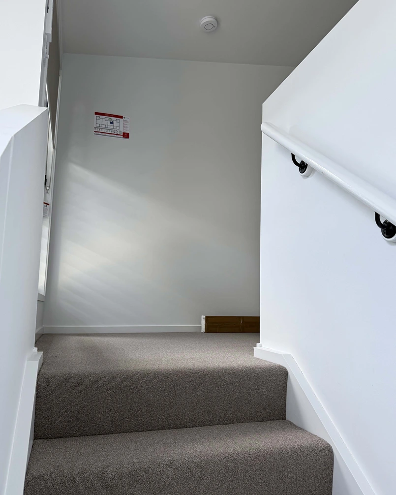 Carpeted stairwell leading to bedroom at You Me and the Community, Acacia Ridge
