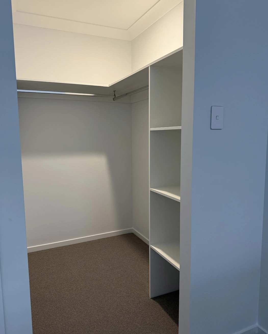 Walk-in wardrobe with shelving at Acacia Ridge You Me and the Community unit