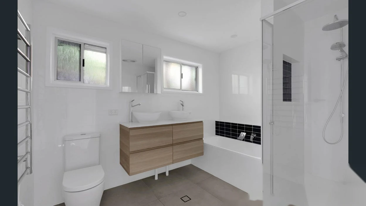 Bright bathroom with bathtub and separate shower at 2 Bejimba Street Kenmore by YMC