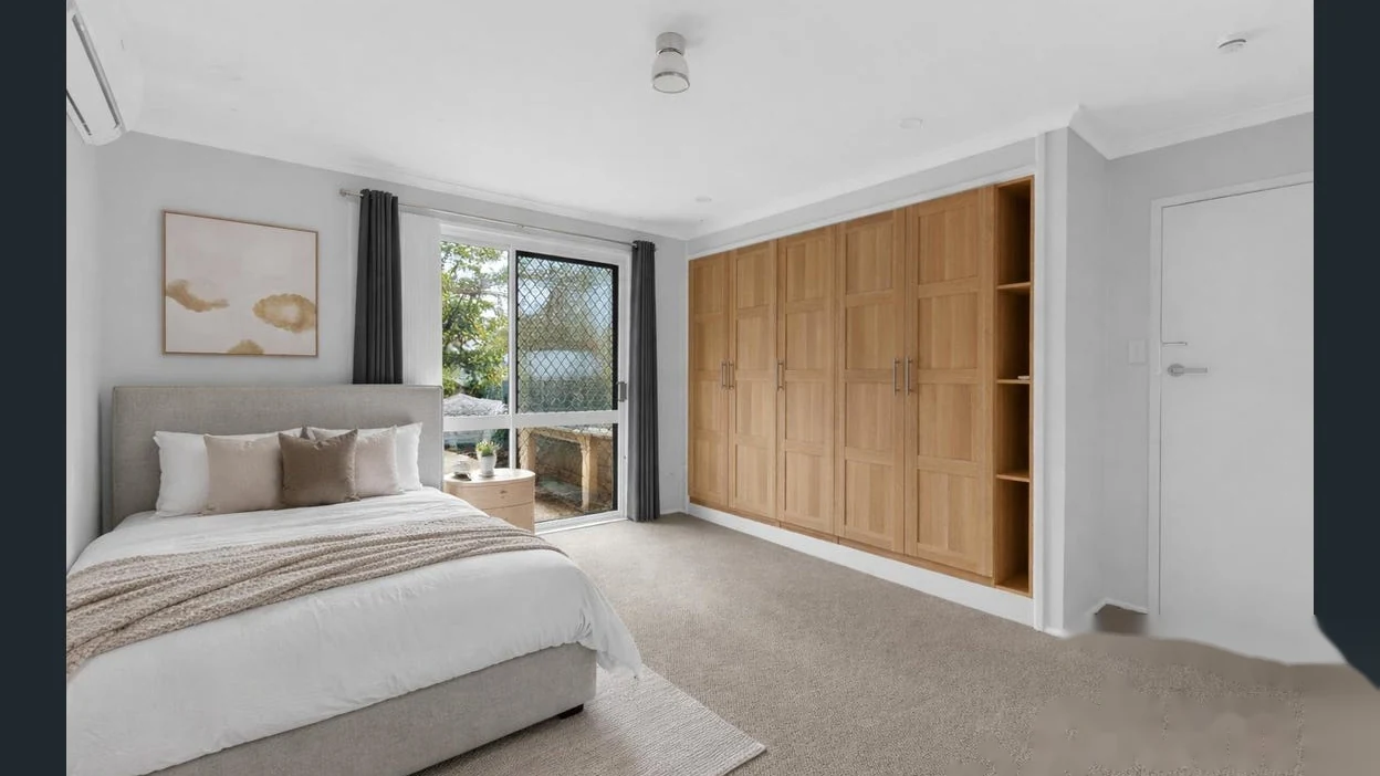 Furnished main bedroom with large built-in wardrobe at 2 Bejimba Street Kenmore by YMC