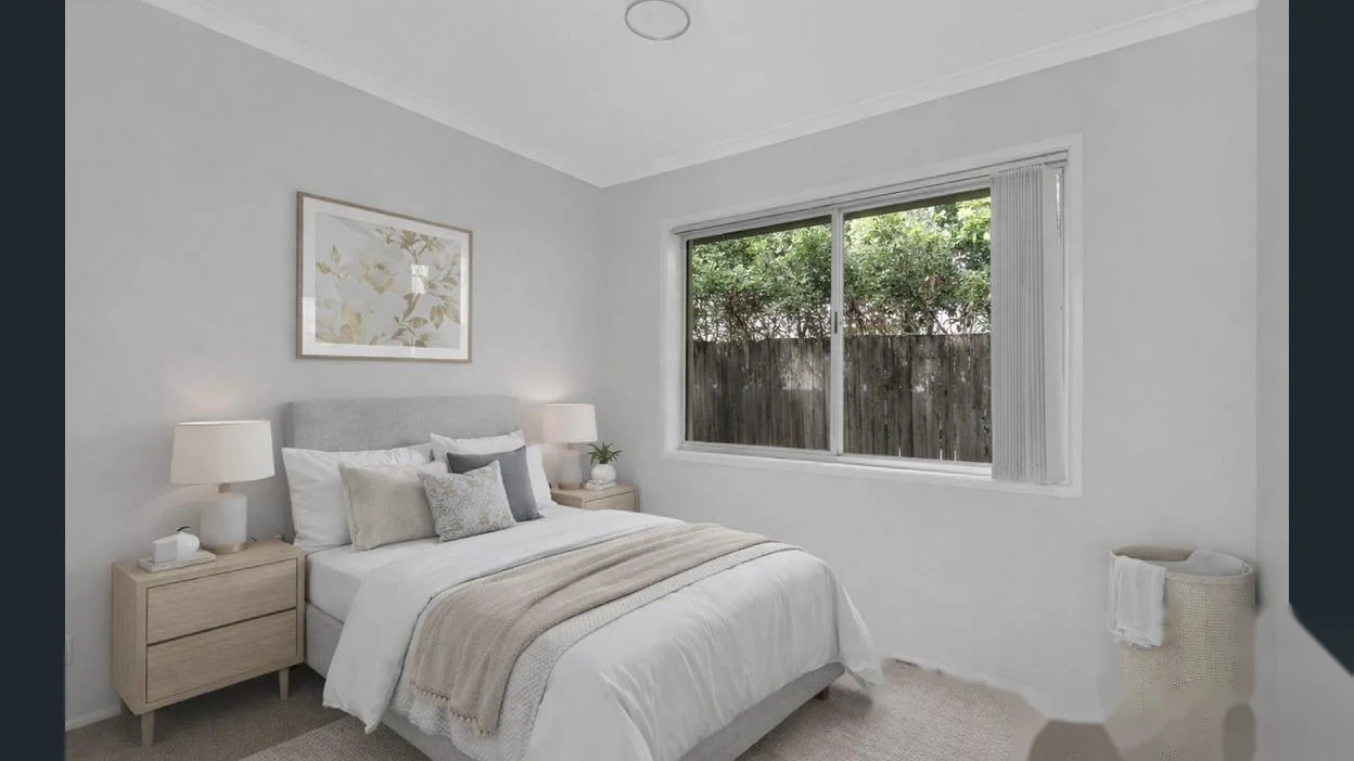 Light-filled bedroom with neutral styling at 2 Bejimba Street Kenmore by YMC