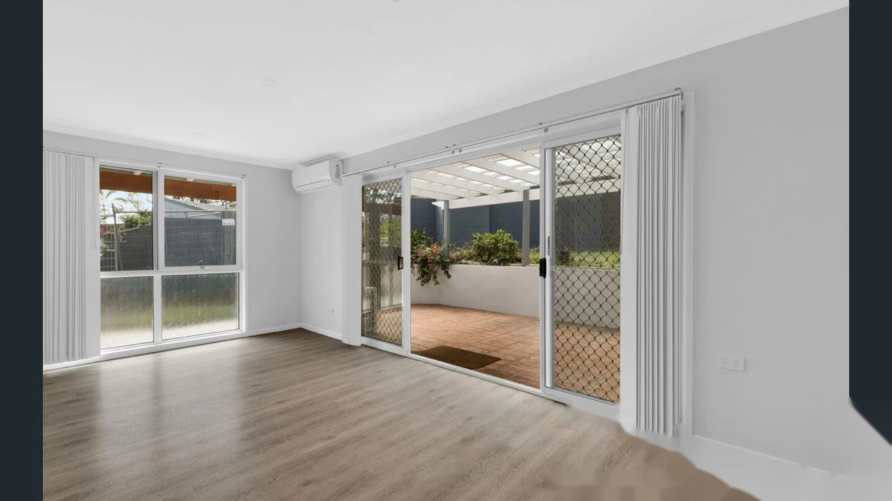 Open living area with sliding doors to covered patio at 2 Bejimba Street Kenmore by YMC