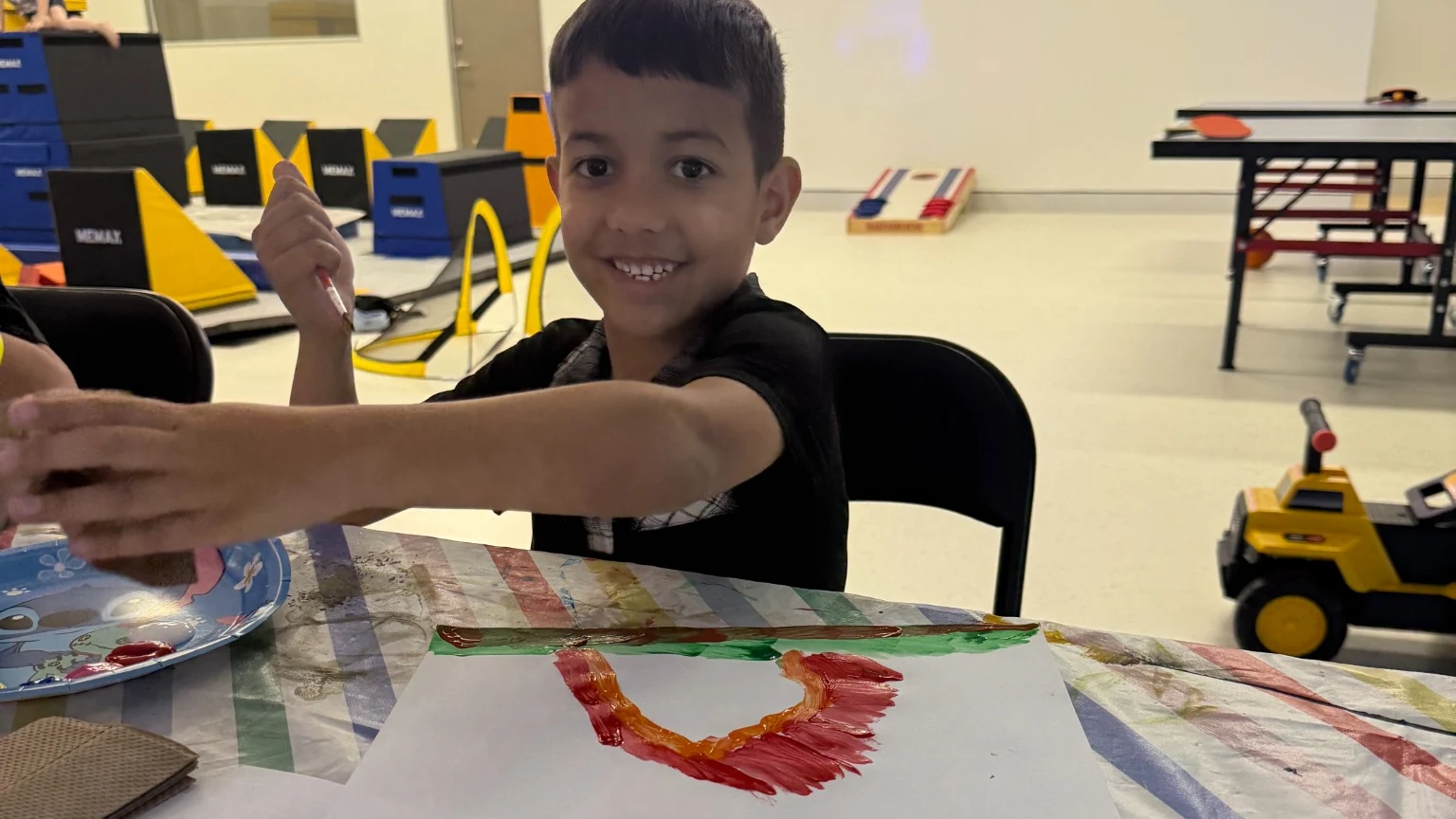 Child enjoying a painting activity at The Legacy Hub Ipswich with You Me and Community