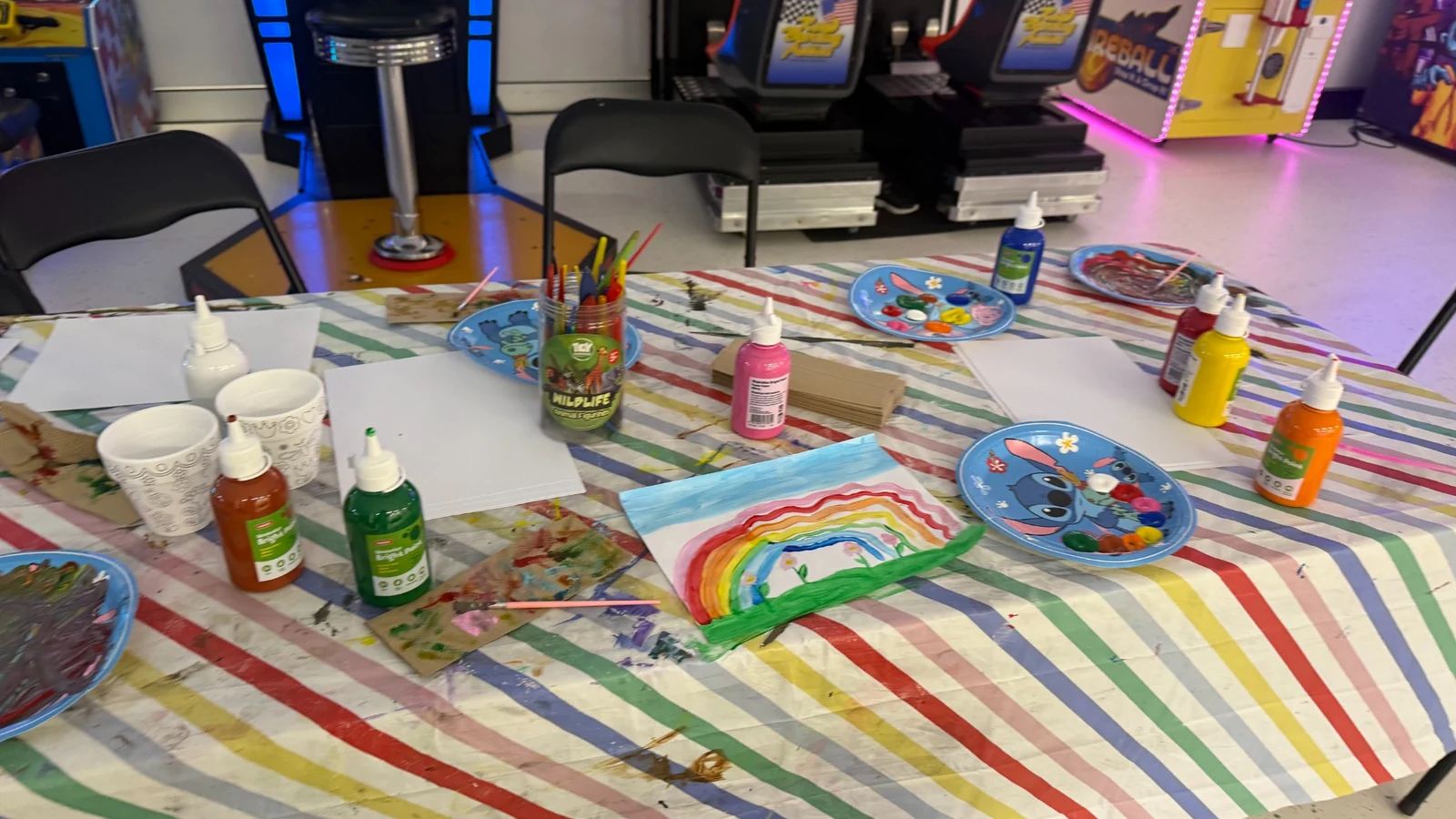 Kids art activity table set up in an Ipswich party space with arcade games at You Me and Community