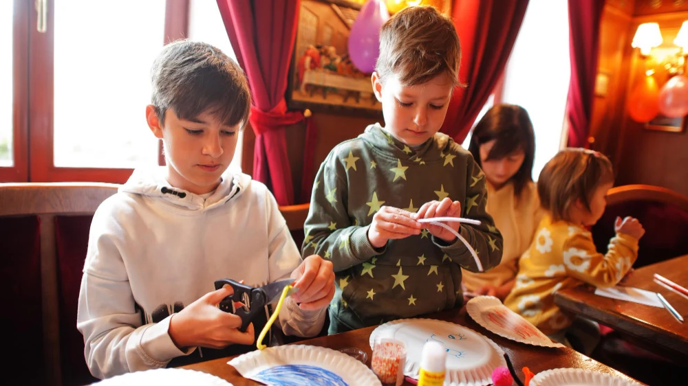 Children enjoying hands-on craft activities at a kids party room in Ipswich at You Me and Community