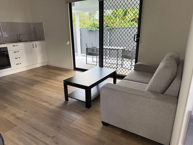 Furnished living room with sofa and sliding patio door at 495 Beatty Road Acacia Ridge