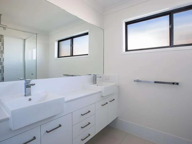 Bathroom vanity with double sink and mirror at 55 Hill Drive Pimpama property