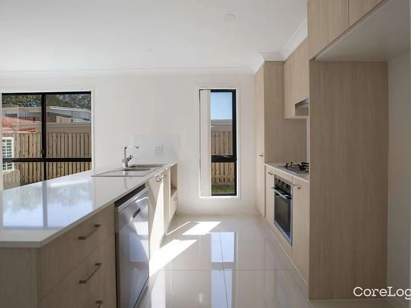 Bright modern kitchen with island bench at 55 Hill Drive Pimpama home