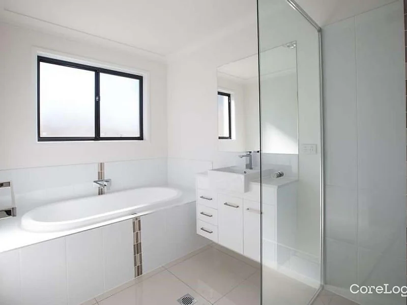 Main bathroom with bathtub shower and white vanity at 55 Hill Drive Pimpama