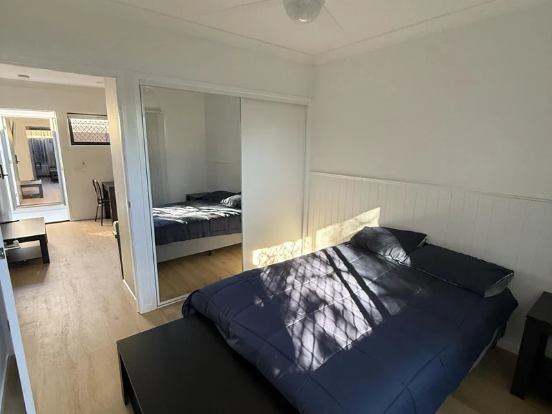 Bedroom with mirrored wardrobe and furnished bed at 89 Marshall Road Rocklea