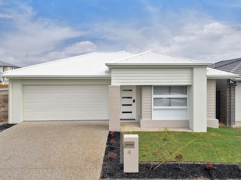Modern front exterior of Logan Reserve QLD 4133 property with double garage, driveway and landscaped front yard.