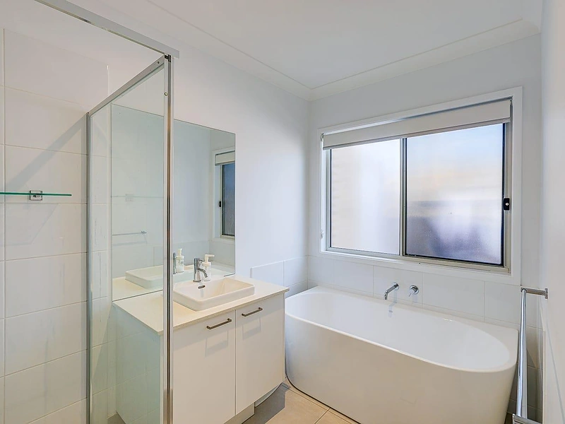Bathroom with bathtub, glass shower and vanity in Greenbank