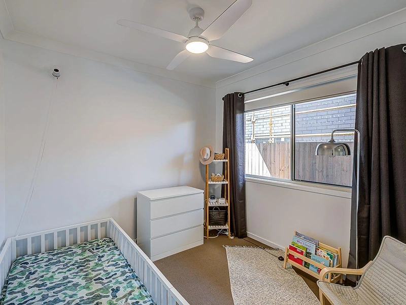 Bedroom with window, ceiling fan and carpeted floor in Greenbank