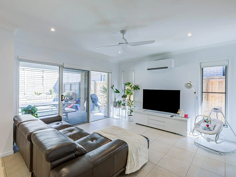 Bright living room with tiled flooring and sliding doors in Greenbank