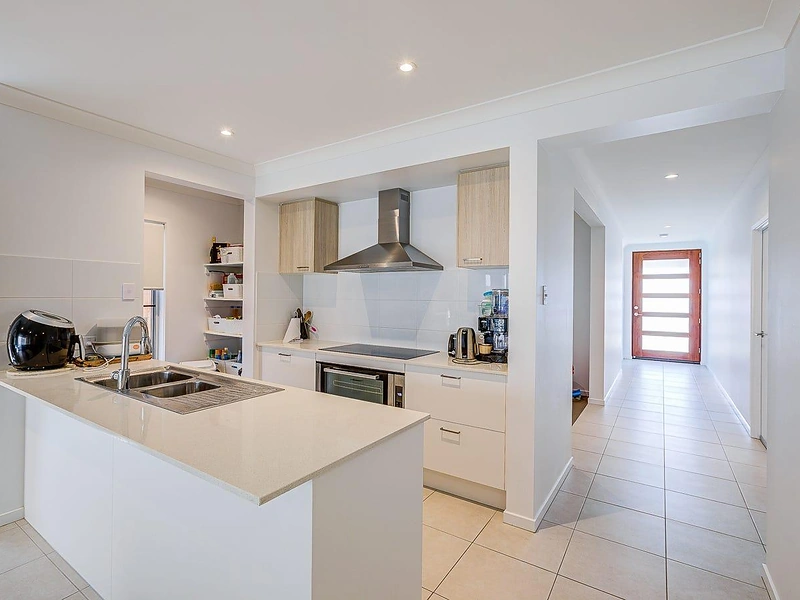 Modern kitchen with island bench, cabinetry and appliances in Greenbank
