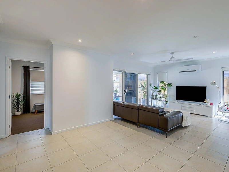 Open-plan living area with tiled flooring and natural light in Greenbank