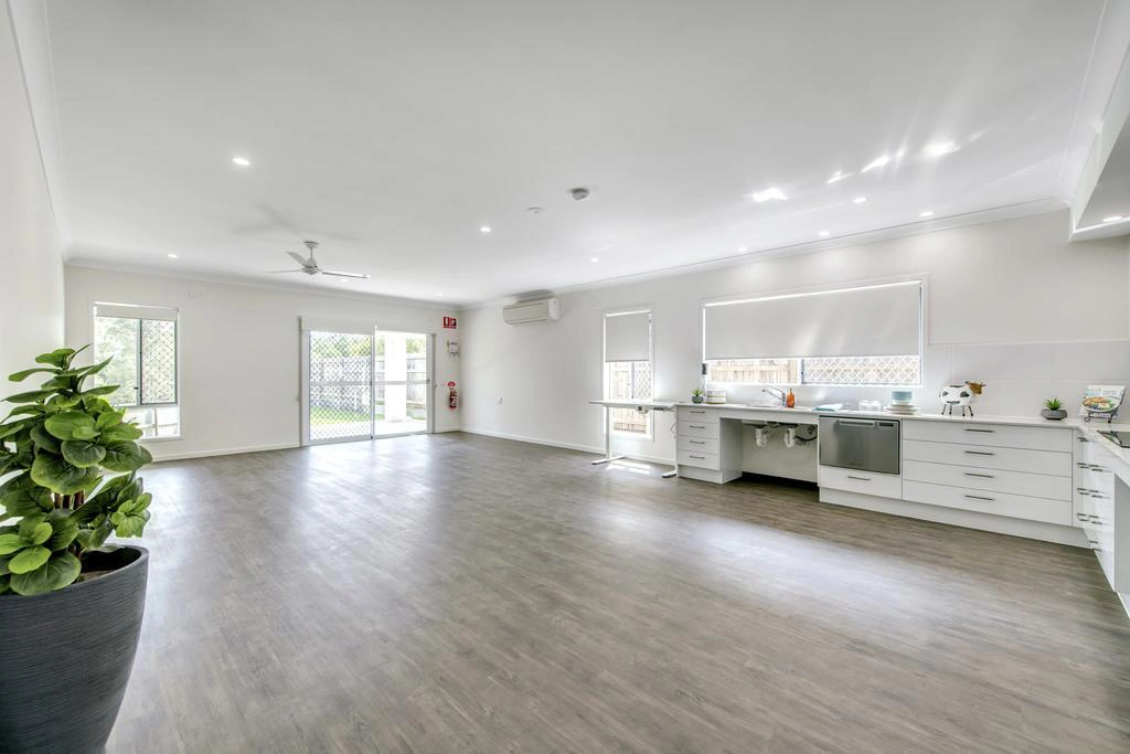 Spacious open living and kitchen area with natural light in Ormeau
